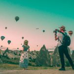 Last-minute Travel - man taking photo of hot air balloons