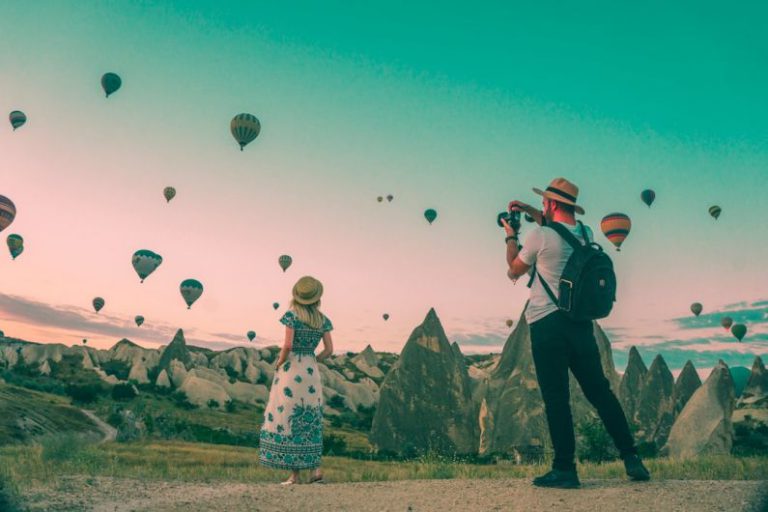 Last-minute Travel - man taking photo of hot air balloons