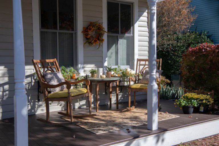 Seasonal Decorations - brown wooden chairs and table near white wooden post