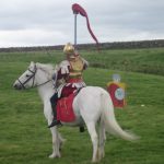 Historic Reenactment - man in white cowboy hat riding white horse during daytime