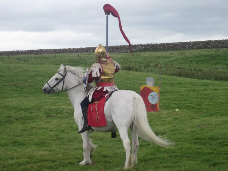 Historic Reenactment - man in white cowboy hat riding white horse during daytime