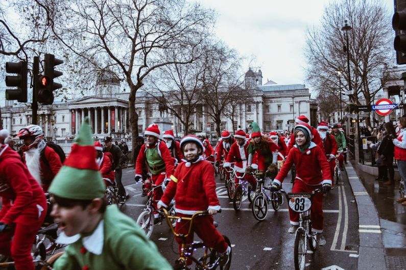 Seasonal Parade - group of children in bicycle near white building