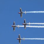 Local Event - four airplanes flying in formation in a blue sky