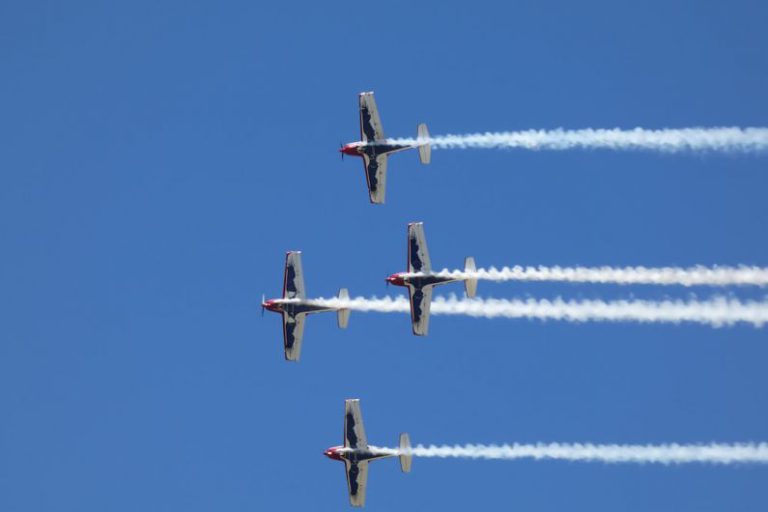 Local Event - four airplanes flying in formation in a blue sky
