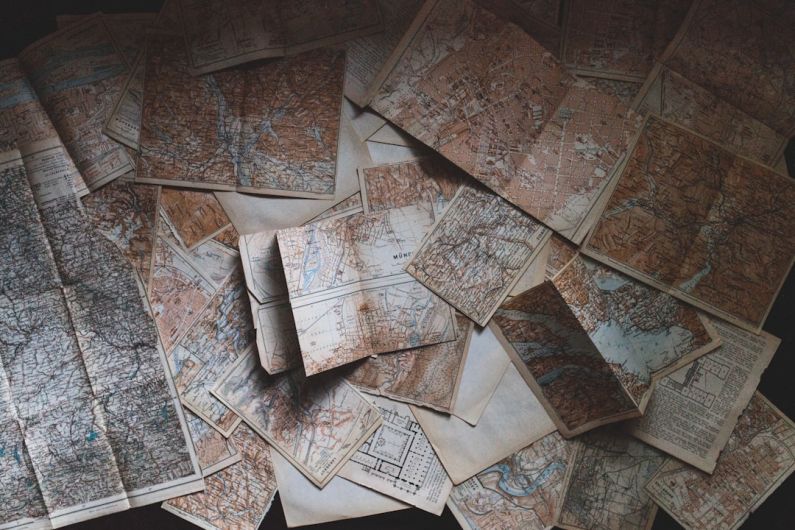 Travel Scams - maps lying on the floor