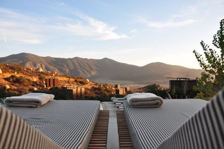 Romantic Luxury B&B - sunloungers fronting buildings near mountain
