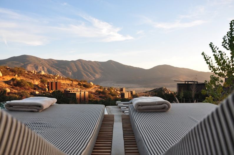 Romantic Luxury B&B - sunloungers fronting buildings near mountain