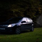 Affordable B&B - a small black car parked in a grassy field