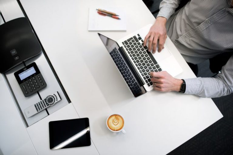 Budget Amenities - person using laptop on white wooden table