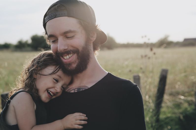 Budget Family B&B - man carrying daughter in black sleeveless top