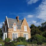 B&B Deals - brown and white concrete house surrounded by green trees under blue sky during daytime