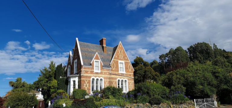 B&B Deals - brown and white concrete house surrounded by green trees under blue sky during daytime