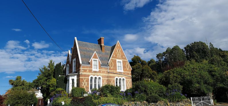 B&B Deals - brown and white concrete house surrounded by green trees under blue sky during daytime