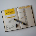 Charming Budget B&B - white planner with pen on top