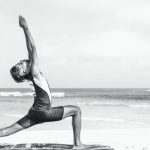 Stretch Budget - man stretching on seashore
