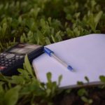 Excellent Budget B&B - blue ballpoint pen on paper beside calculator