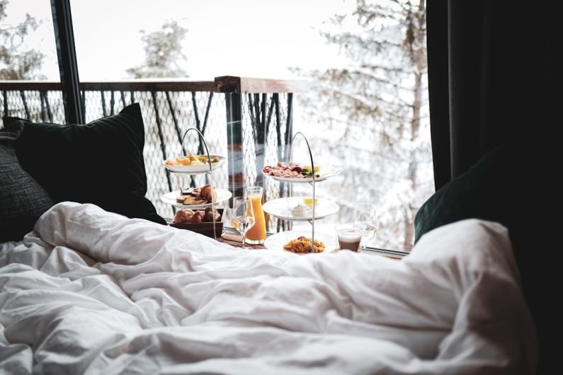Luxury Bed And Breakfast - a bed with a tray of food on top of it