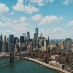 New York City Skyline - wide angle photo of Brooklyn Bridge under cloudy sky