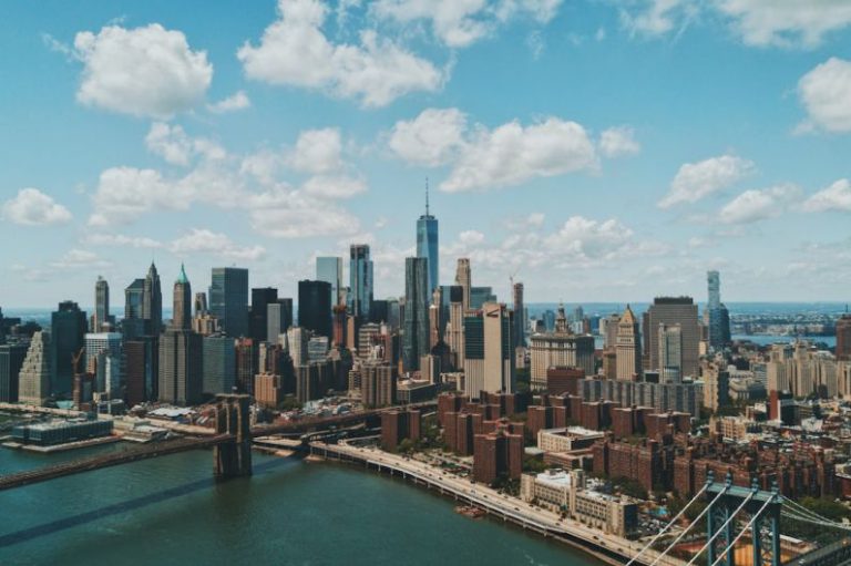 New York City Skyline - wide angle photo of Brooklyn Bridge under cloudy sky