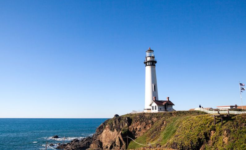 California Coastline - a lighthouse on a hill by the water
