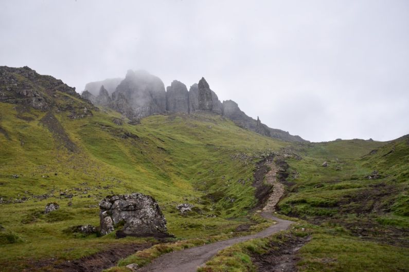 Scottish Landscape - a dirt road on a grassy hill