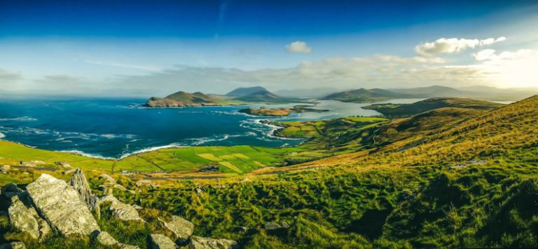 Irish Landscape - green grass field near body of water during daytime