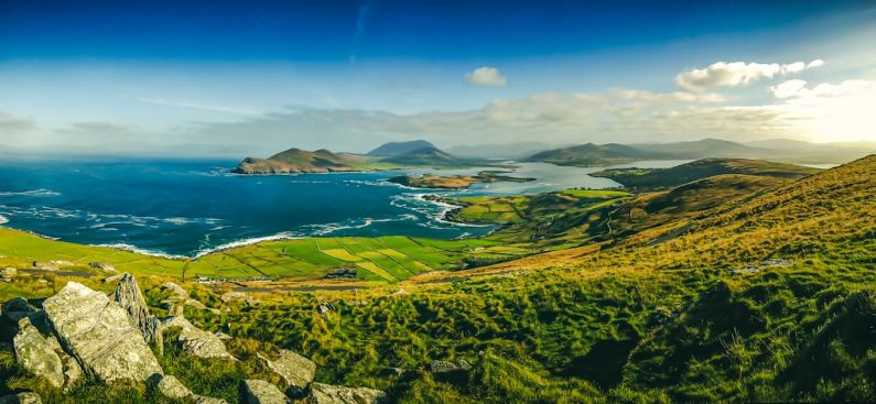 Irish Landscape - green grass field near body of water during daytime