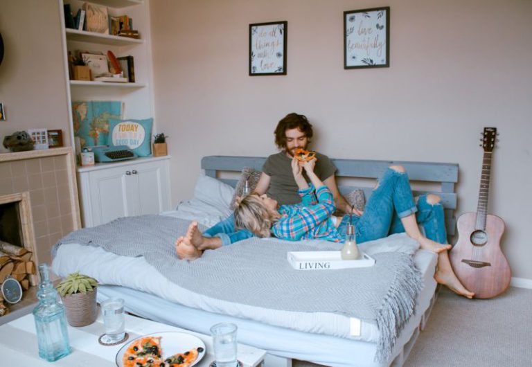 Family At Bed And Breakfast - man and woman lying on bed