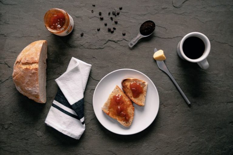 Breakfast Spread - white ceramic plate with stainless steel fork and bread knife