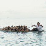 Local Culture - man riding boat during daytime