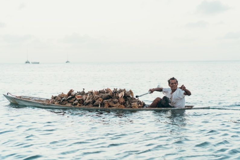 Local Culture - man riding boat during daytime