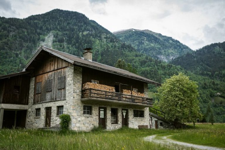 Nature Bed And Breakfast - brown wooden house on green grass field near green mountain during daytime