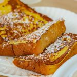 French Toast - brown bread on white ceramic plate