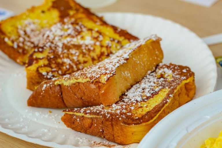 French Toast - brown bread on white ceramic plate