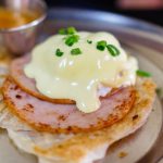 Eggs Benedict - melted cheese on top of cooked ham
