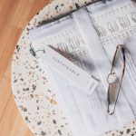 Sustainable B&B - silver framed eyeglasses on white and blue floral textile