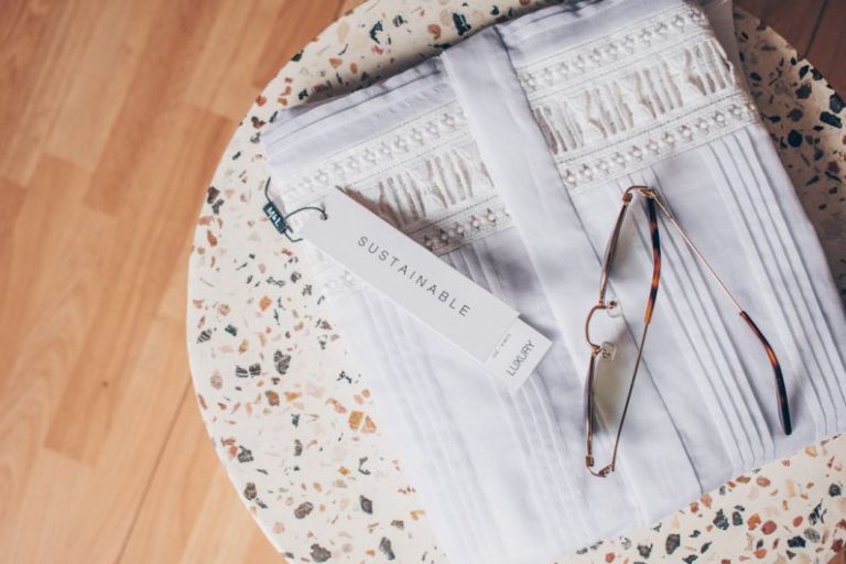 Sustainable B&B - silver framed eyeglasses on white and blue floral textile