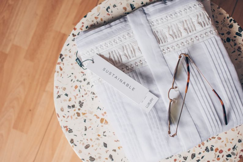 Sustainable B&B - silver framed eyeglasses on white and blue floral textile
