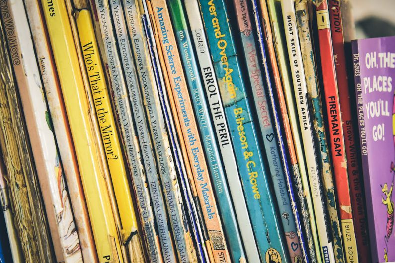 Owner Stories - pile of assorted-title books