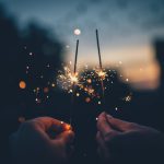New Year's Eve B&B - person holding fire cracker shallow focus photography