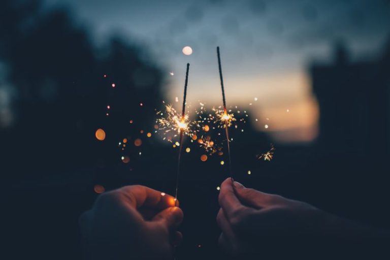 New Year's Eve B&B - person holding fire cracker shallow focus photography